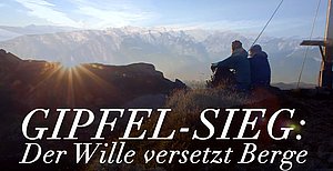 Werbetafel mit der Aufschrift Gipfel-Sieg: Der Wille versetzt Berge